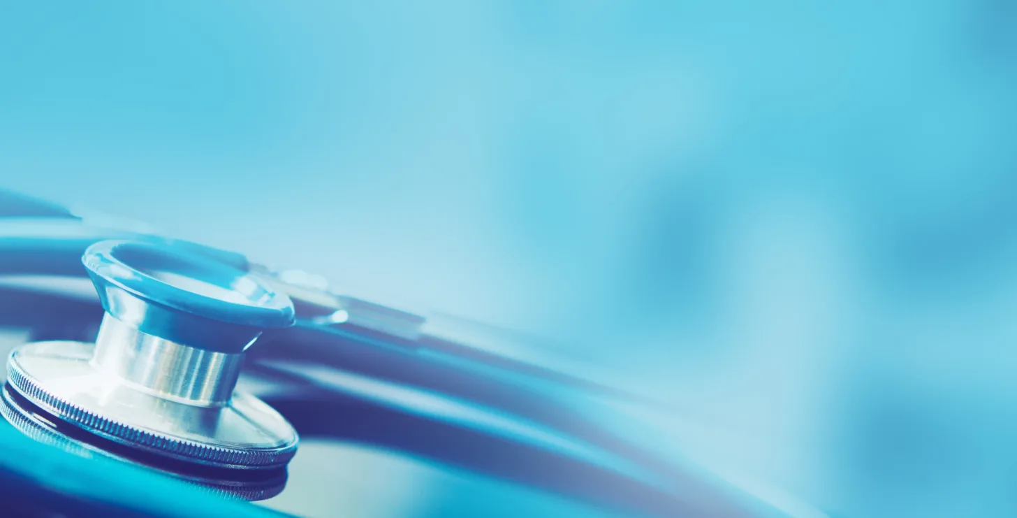 Close-up of a stethoscope with a blue, blurred background, evoking the diligence and precision required by a San Francisco healthcare fraud lawyer.