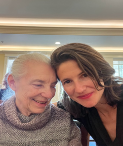 Poppy Alexander pulls her mother into a side hug for the photo. Poppy looks directly at the camera and smiles while her mother faces toward Poppy, smiling as well.