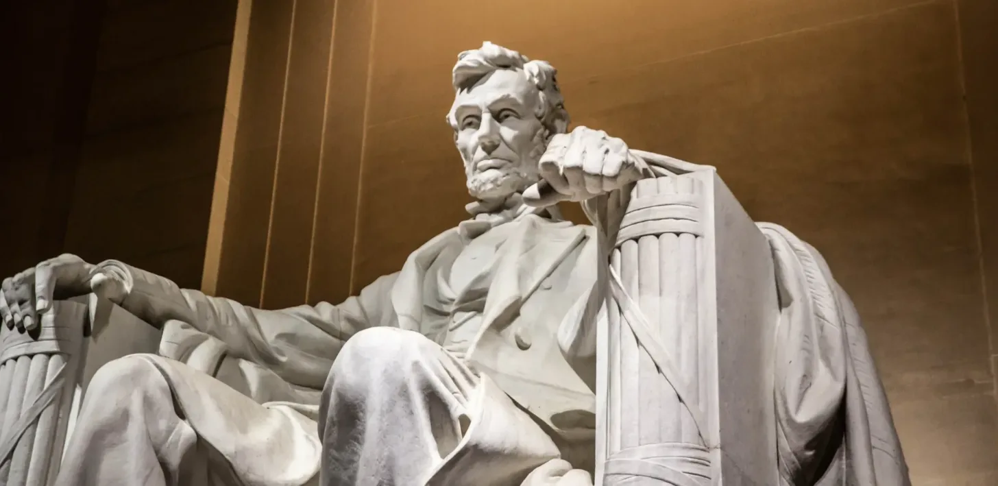 Marble statue of a seated Abraham Lincoln at the Lincoln Memorial, with detailed facial features and hands, against a brown-toned background—a striking image reminiscent of the integrity upheld by a San Francisco healthcare fraud lawyer.