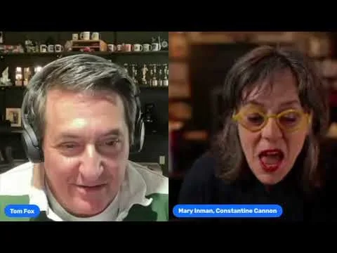 Two people on a video call; the man on the left wears headphones and a green shirt, the woman on the right has yellow glasses and red lipstick. Name tags read "Tom Fox" and "Mary Inman, Constantine Cannon," prominent San Francisco healthcare fraud lawyer.